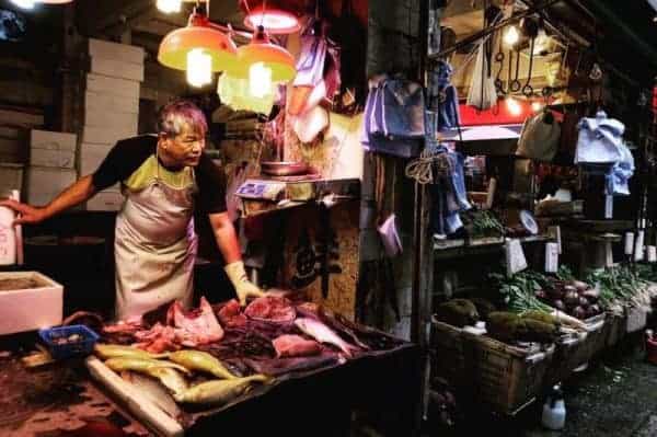 A butcher selling meat at the market