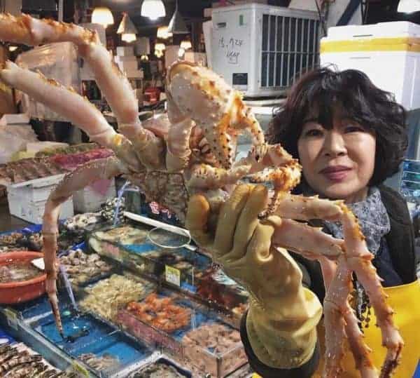 A woman showing a crab