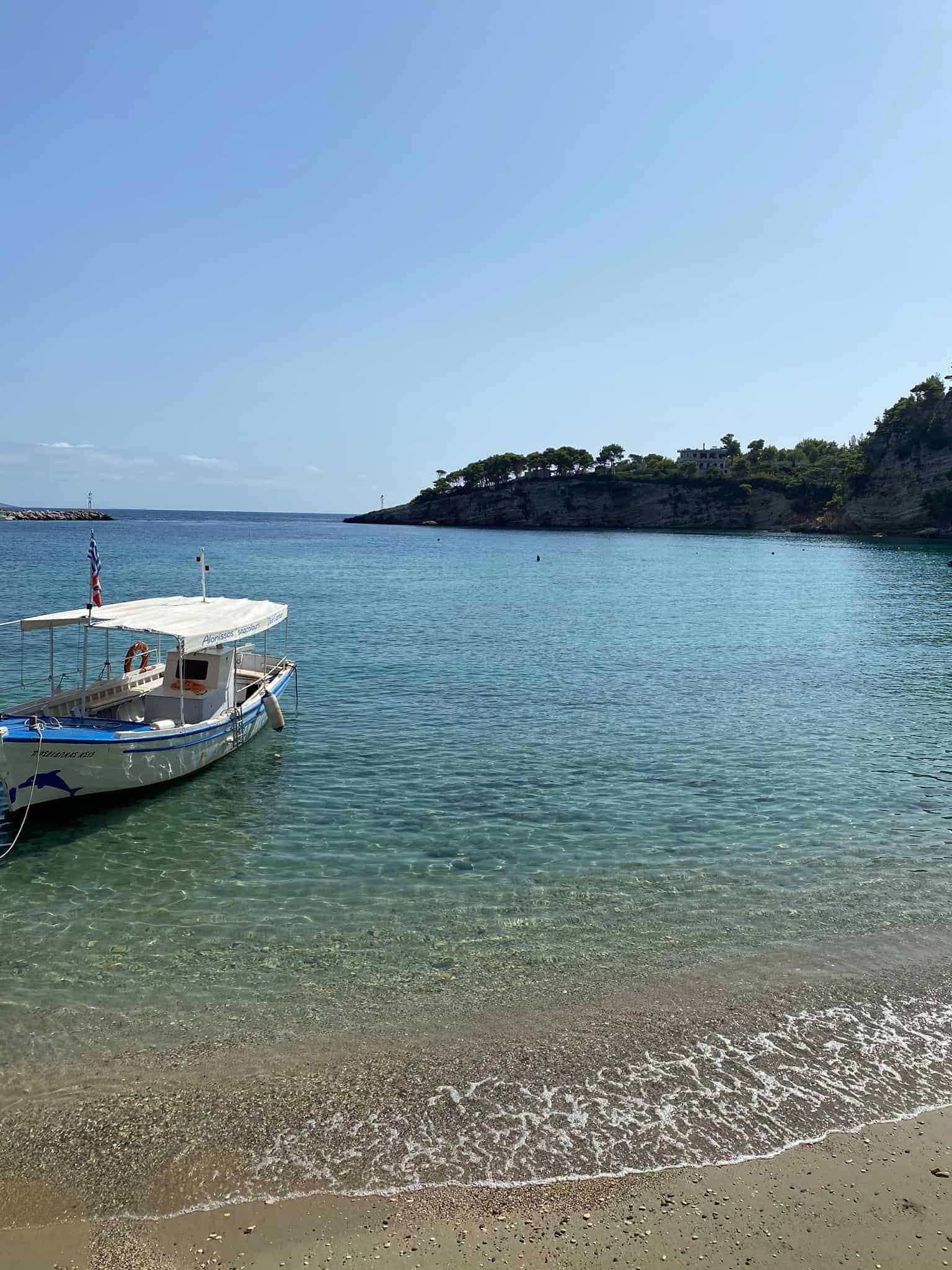 A scenic view of the sea with a boat nearby.