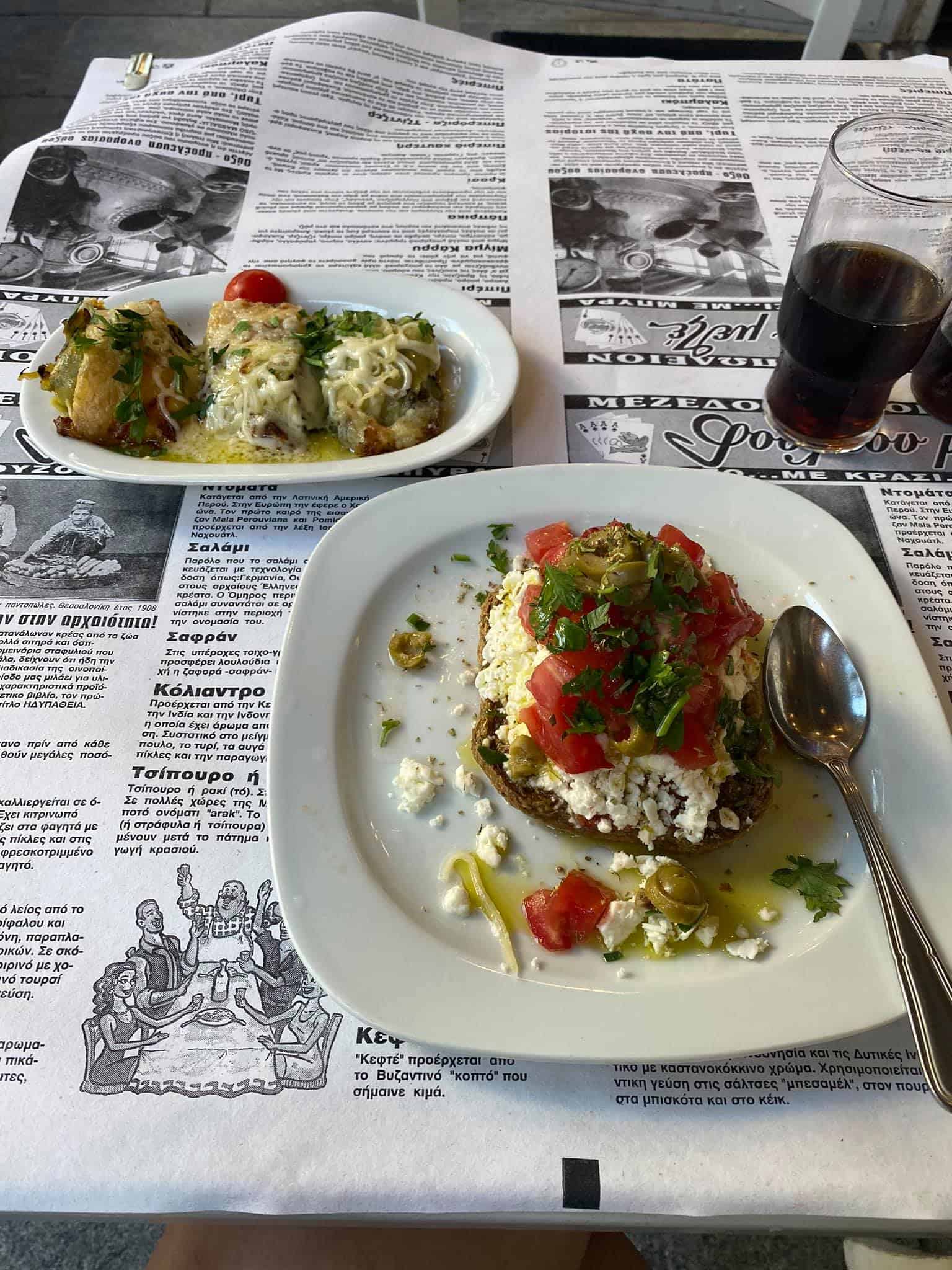 A table set with two plates of food and a glass of wine