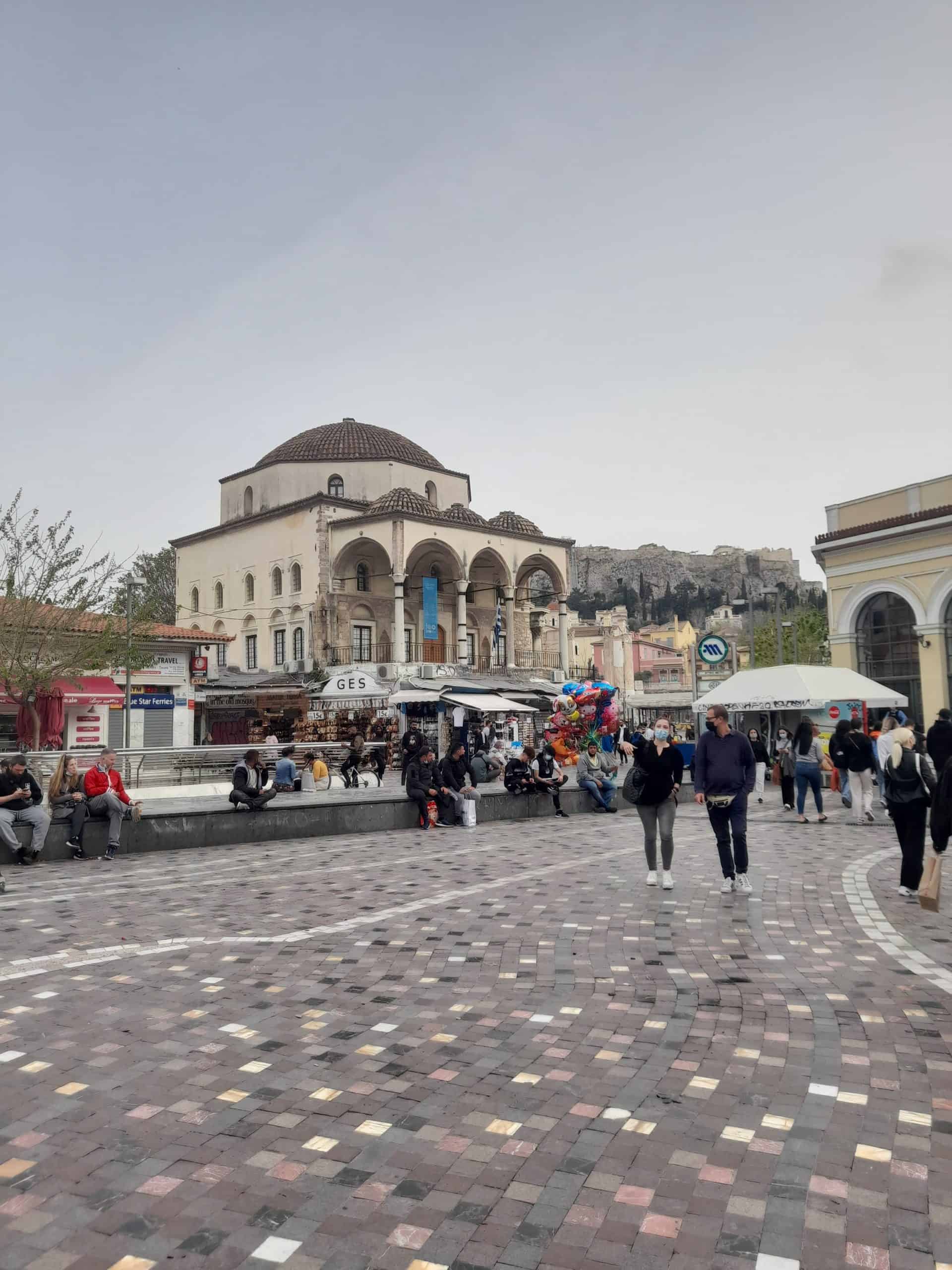 People of various backgrounds walk leisurely in a plaza