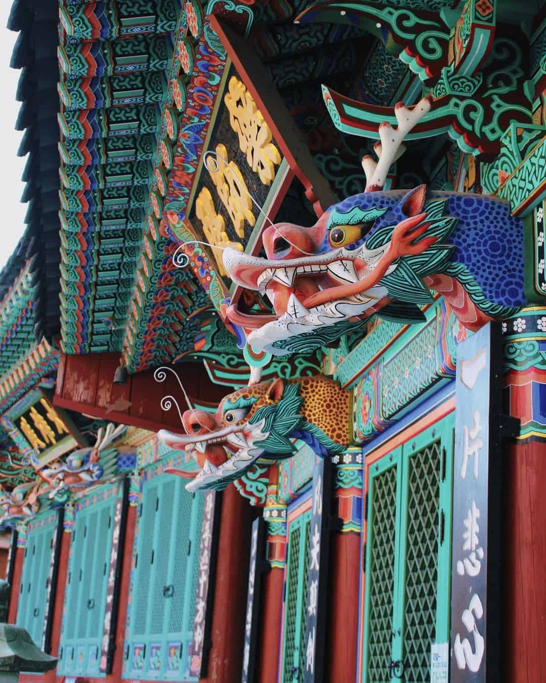 Dragon heads adorn the roof of a traditional Korean building