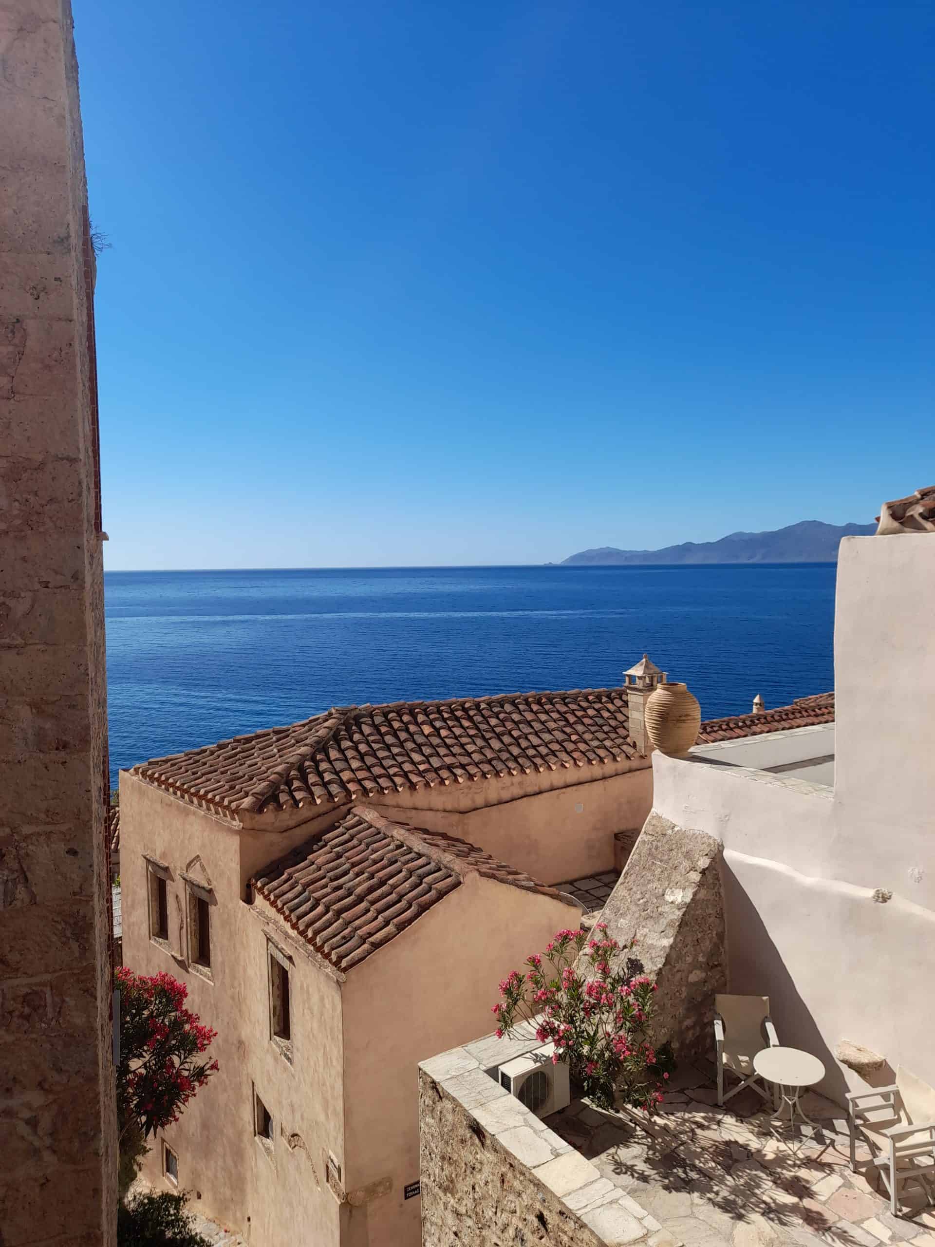 A scenic view of the sea from the window of an old building