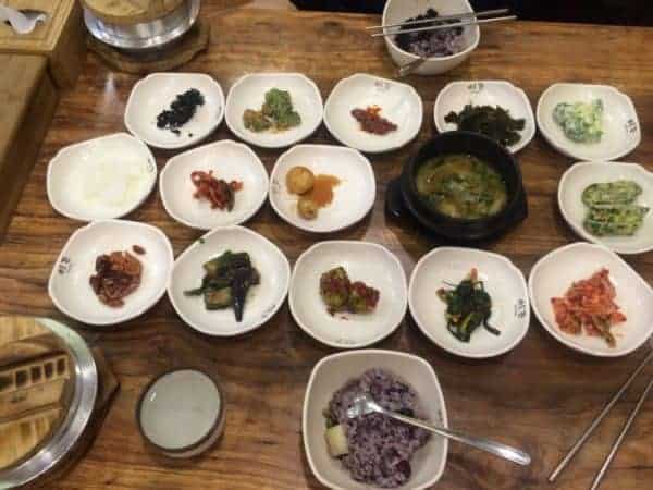 A table set with multiple bowls of food