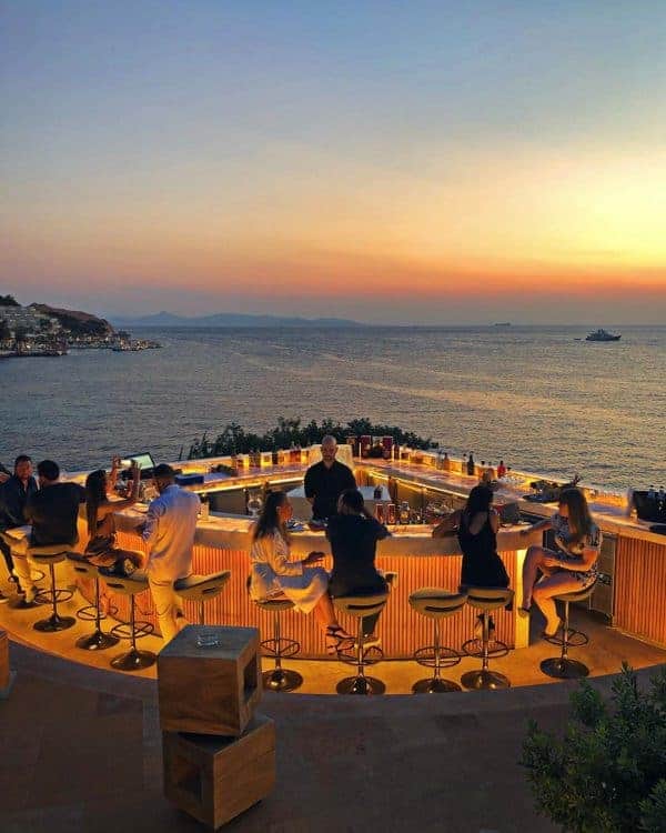 Individuals relaxing at a seaside bar