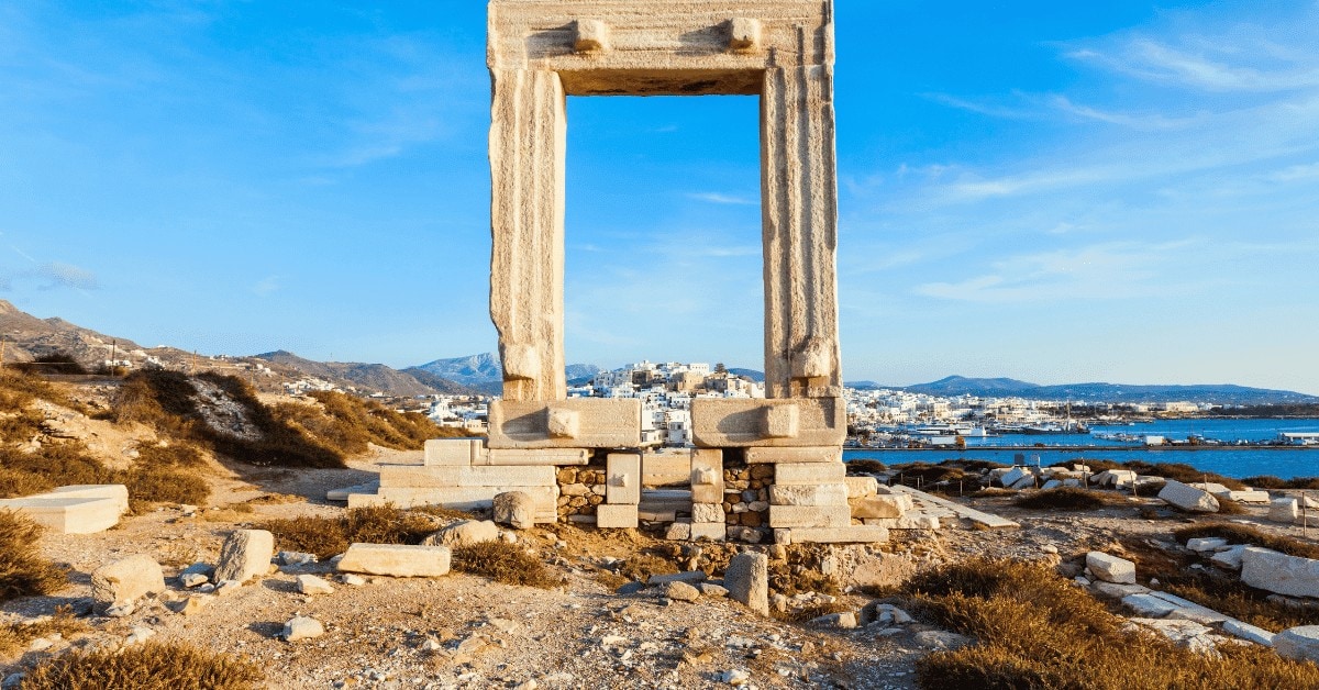 An ancient Greek temple stands majestically in the center of the island