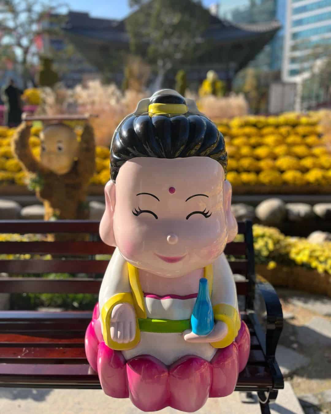 A charming statue depicting a Korean woman sitting on a bench