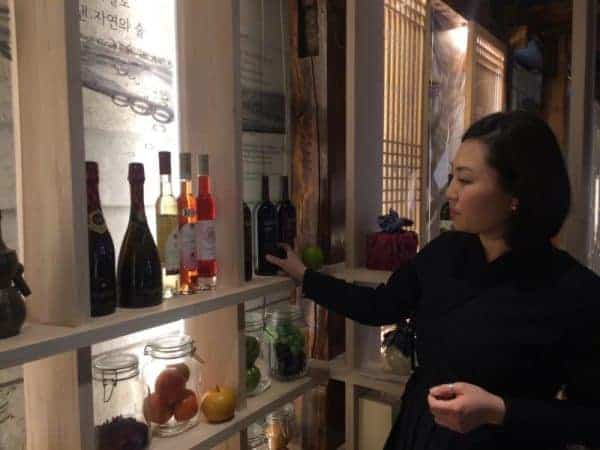 A women checking out the various Korean alcoholic beverages