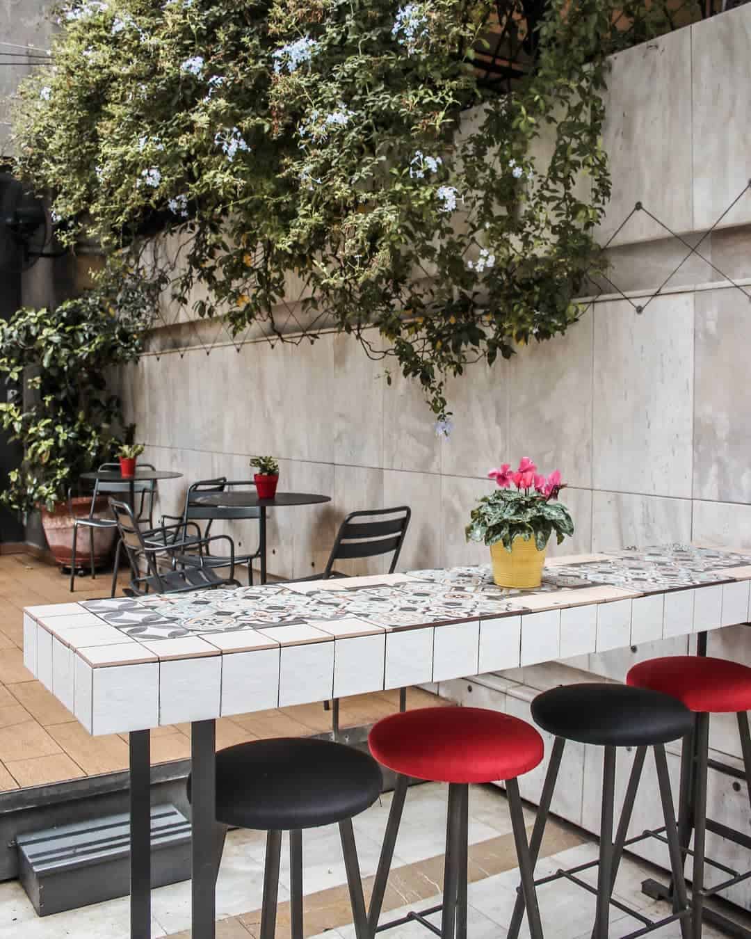 A cozy patio featuring a table surrounded by chairs