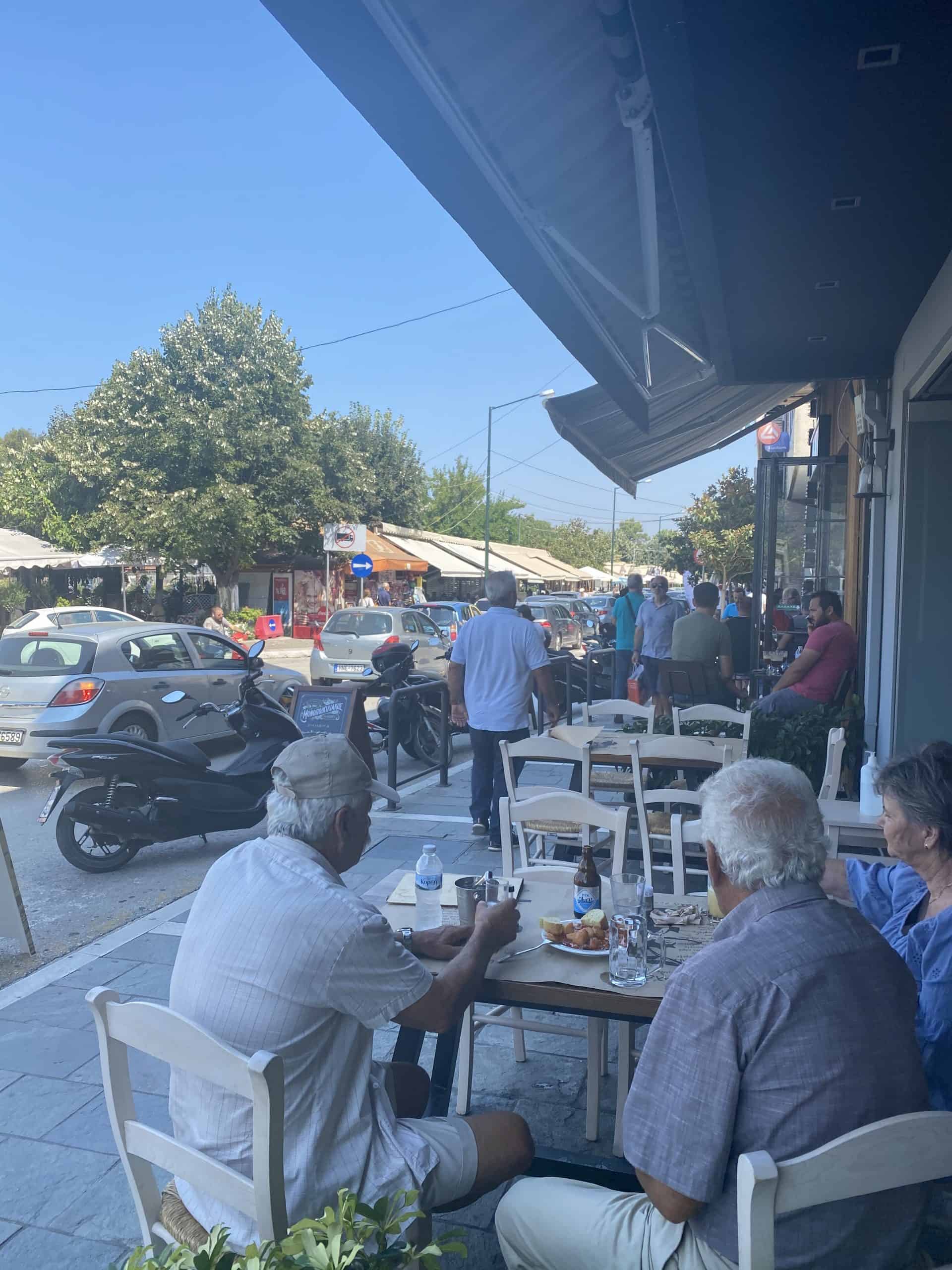 A group of individuals dining at outdoor tables