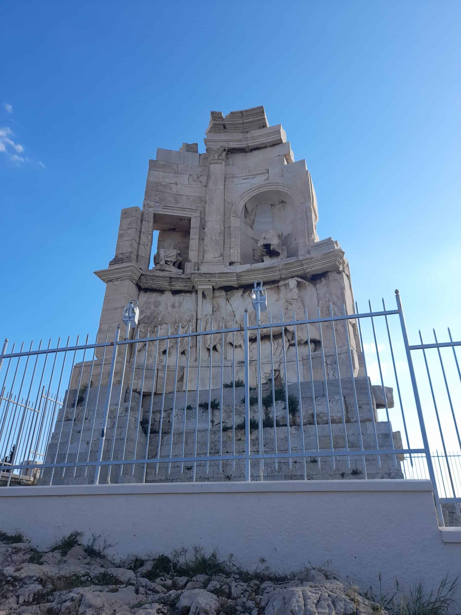 A stone monument enclosed by a fence