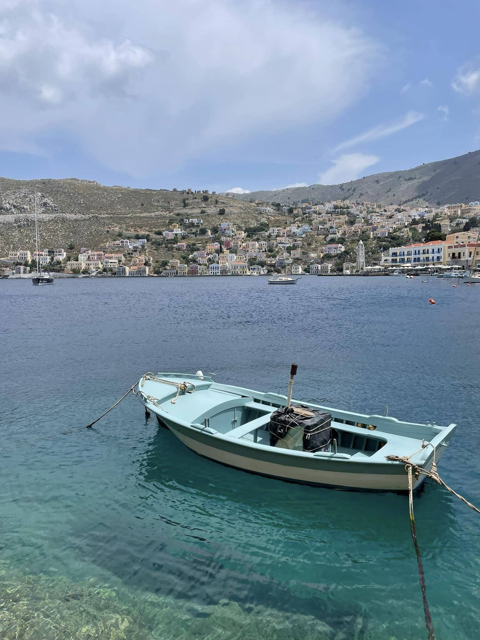 A small boat rests at a dock in tranquil waters