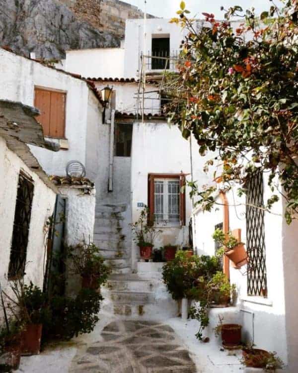 A narrow street lined with white houses