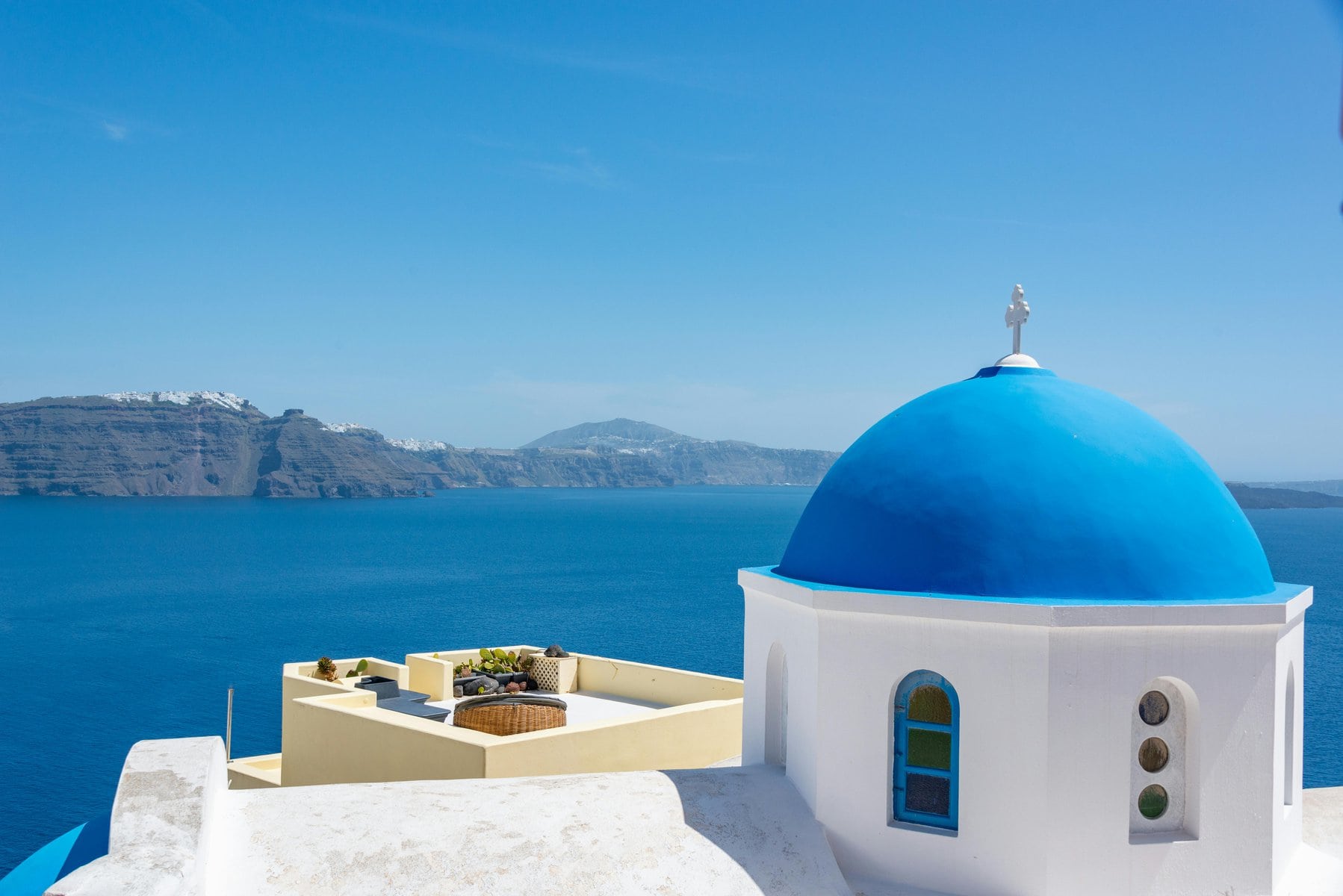 A picturesque blue-domed church on the island of Santorini, Greece