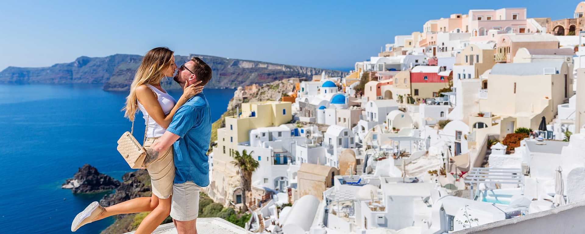 A couple enjoying a romantic moment on a picturesque beach in Greece