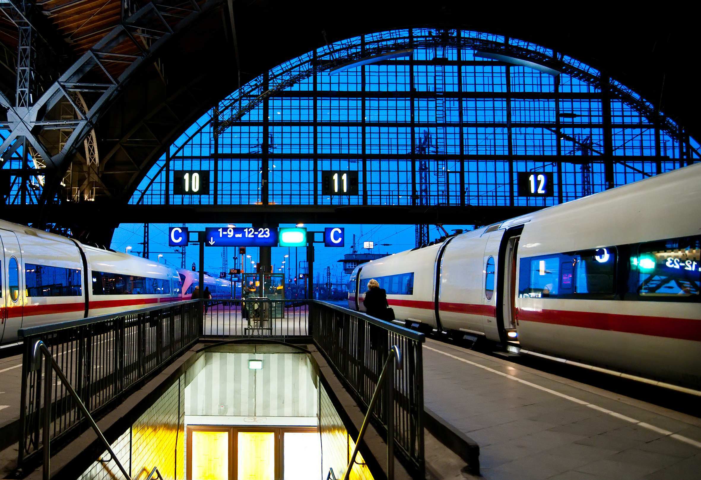 Two trains are stationary at a train station