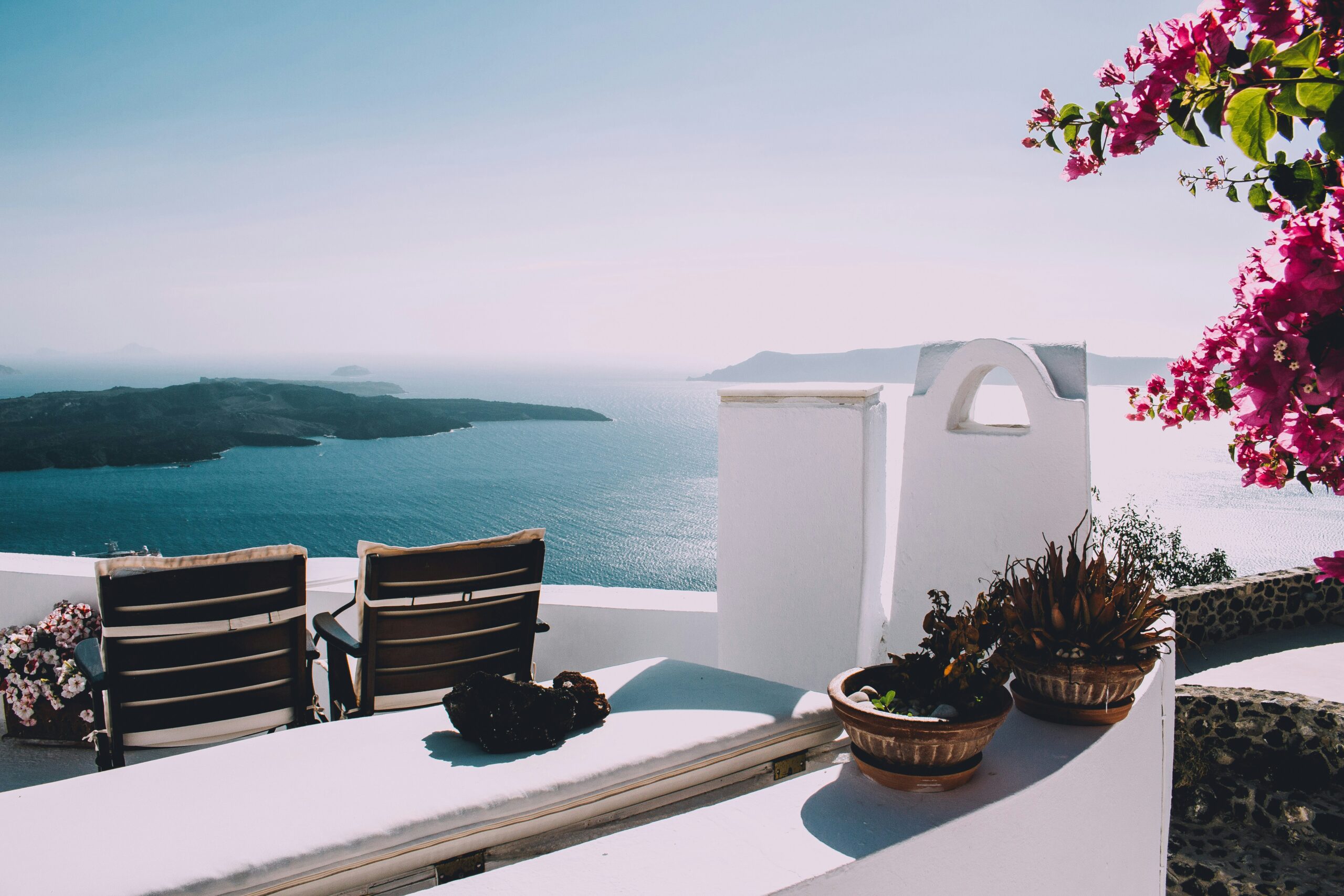 Scenic view of the sea and Santorini island from a villa terrace, showcasing the beauty of Greece's landscape