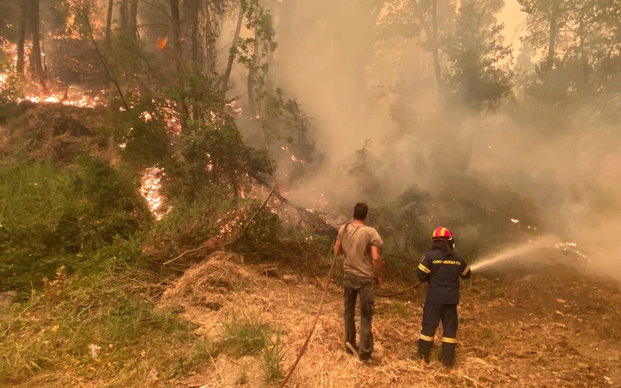 Firefighters using hoses to extinguish a fire