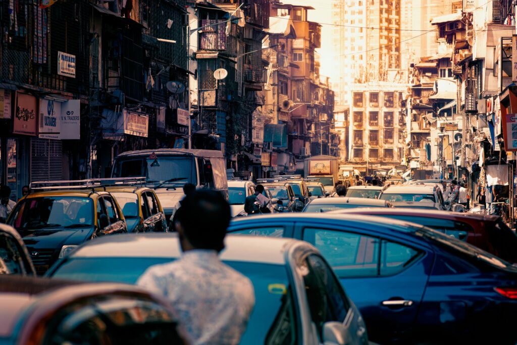 Busy urban street filled with traffic and buildings, depicting city congestion and daily hustle