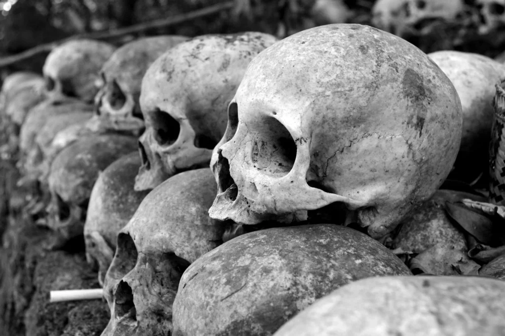 Close-up aof weathered human skulls, conveying mystery and eerie history in a dark atmospheric setting