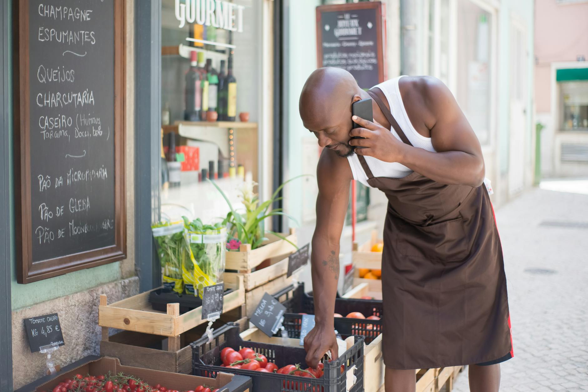 Street vendor selling fresh produce at a Portuguese market, showcasing vibrant local foods and cultural experiences.