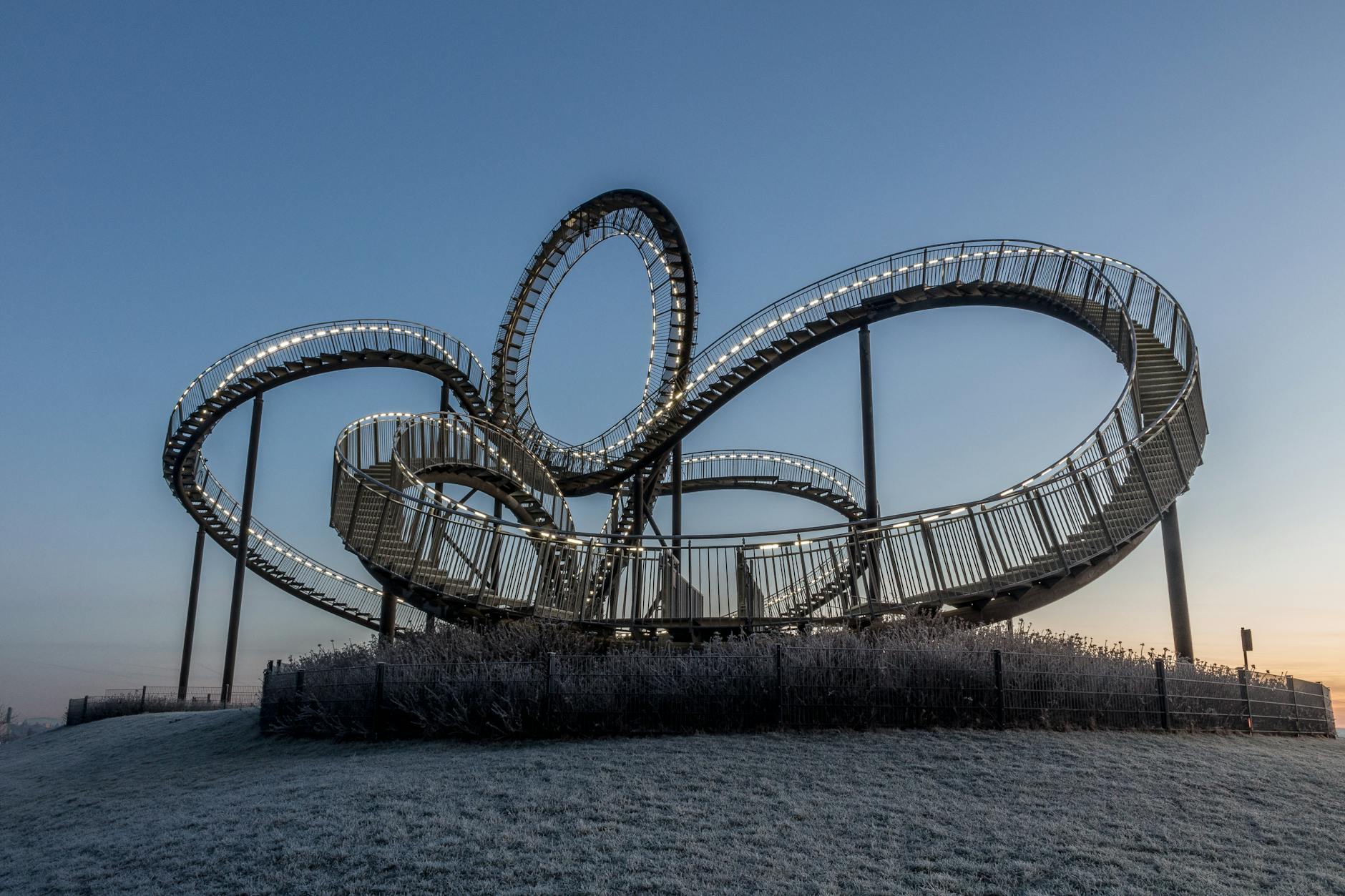 Tiger and Turtle sculpture at twilight, a unique modern landmark in Duisburg, Germany