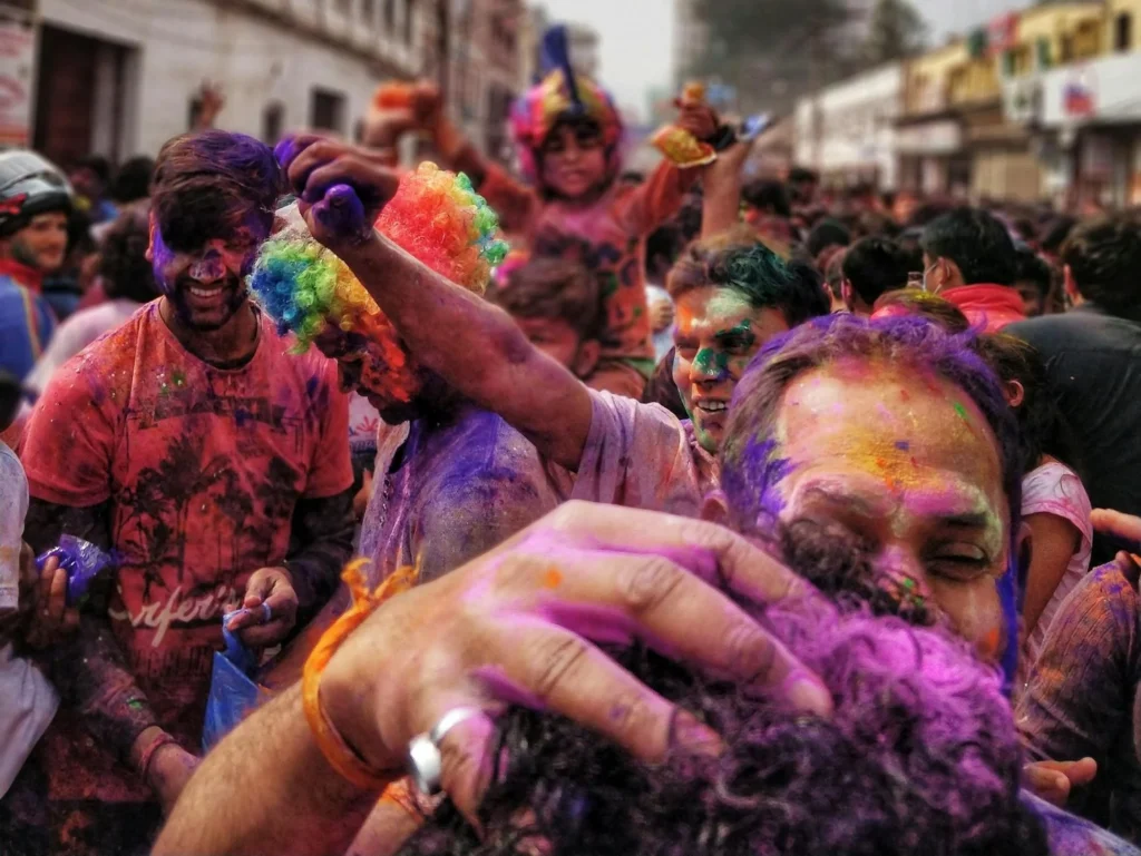 Vibrant Holi festival celebration with people joyfully playing with colorful powder in a lively crowd