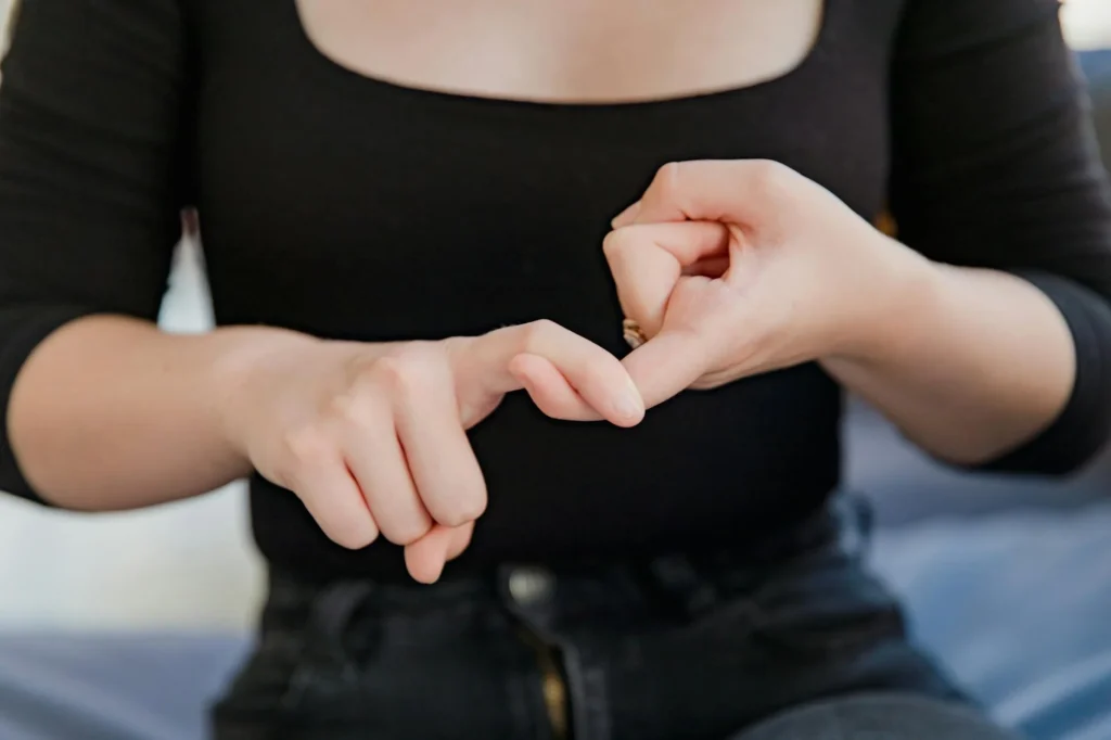 Woman using expressive hand gestures in sign language, highlighting non-verbal communication and inclusivity