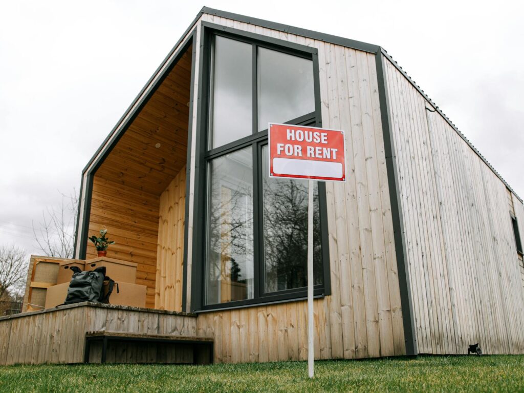 modern home with a for rent sign