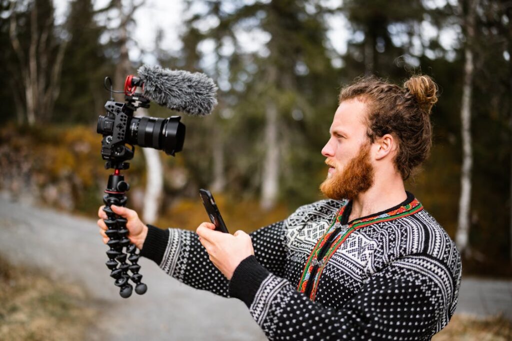 a man holding a camera and a phone