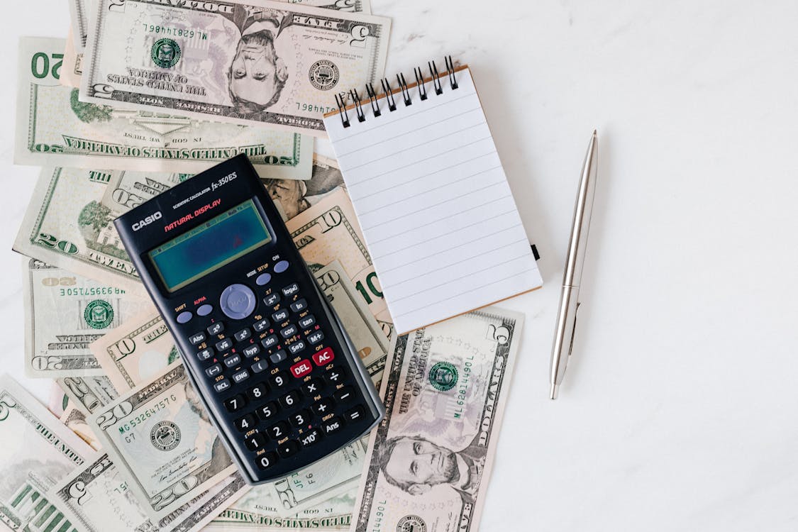 money, calculator and notepad
