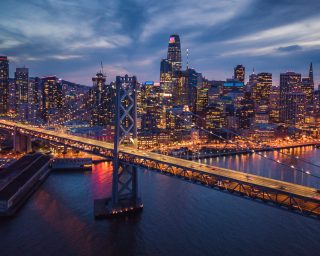 Aerial Cityscape view of San Francisco and the Bay Bridge at Nig