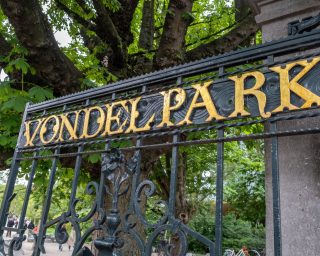 Amsterdam Vondelpark entrance gate open, gold letter text. Vondel park, Dutch garden. Netherlands