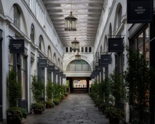 Covered walkway in Covent Garden with shops and hanging lamps