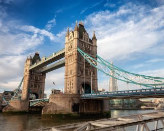 Historic Bridge over River Thames and Cityscape Skyline during dramatic sunrise. Tower Bridge