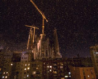 Night view of Sagrada Familia and houses in Barcelona, Spain