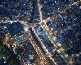 Overhead view of skyscrapers and highways at night, Tokyo, Japan