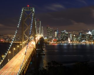 San Francisco Bay Bridge and skyline at night